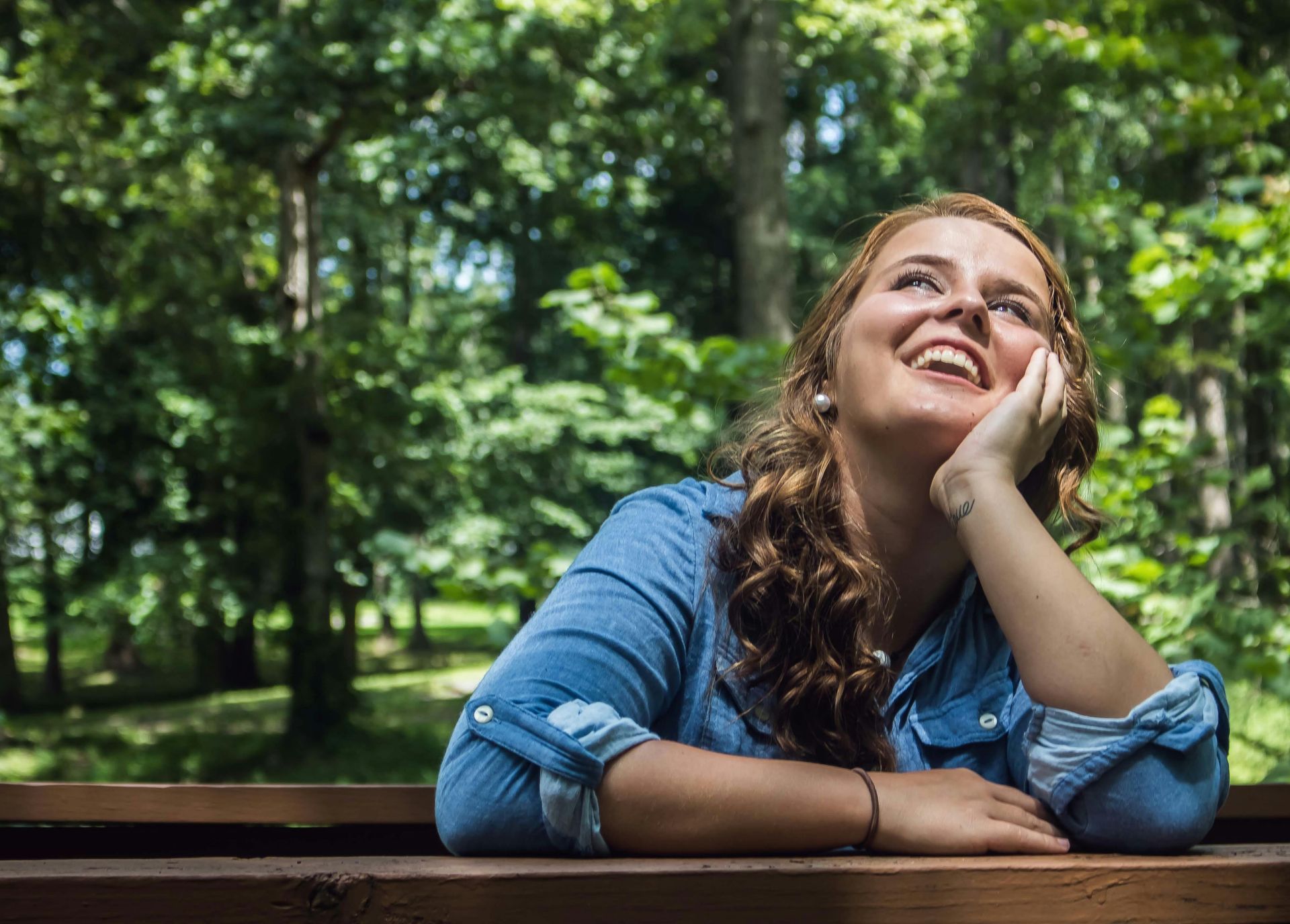 A lady smiling while looking up | Overcome Doubt: Have Faith in God