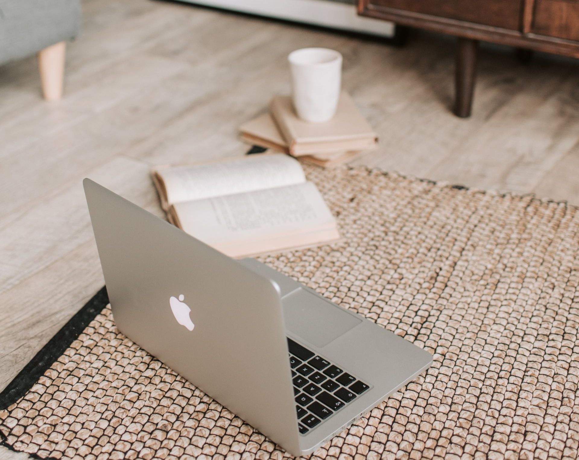 Macbook and study book on floor