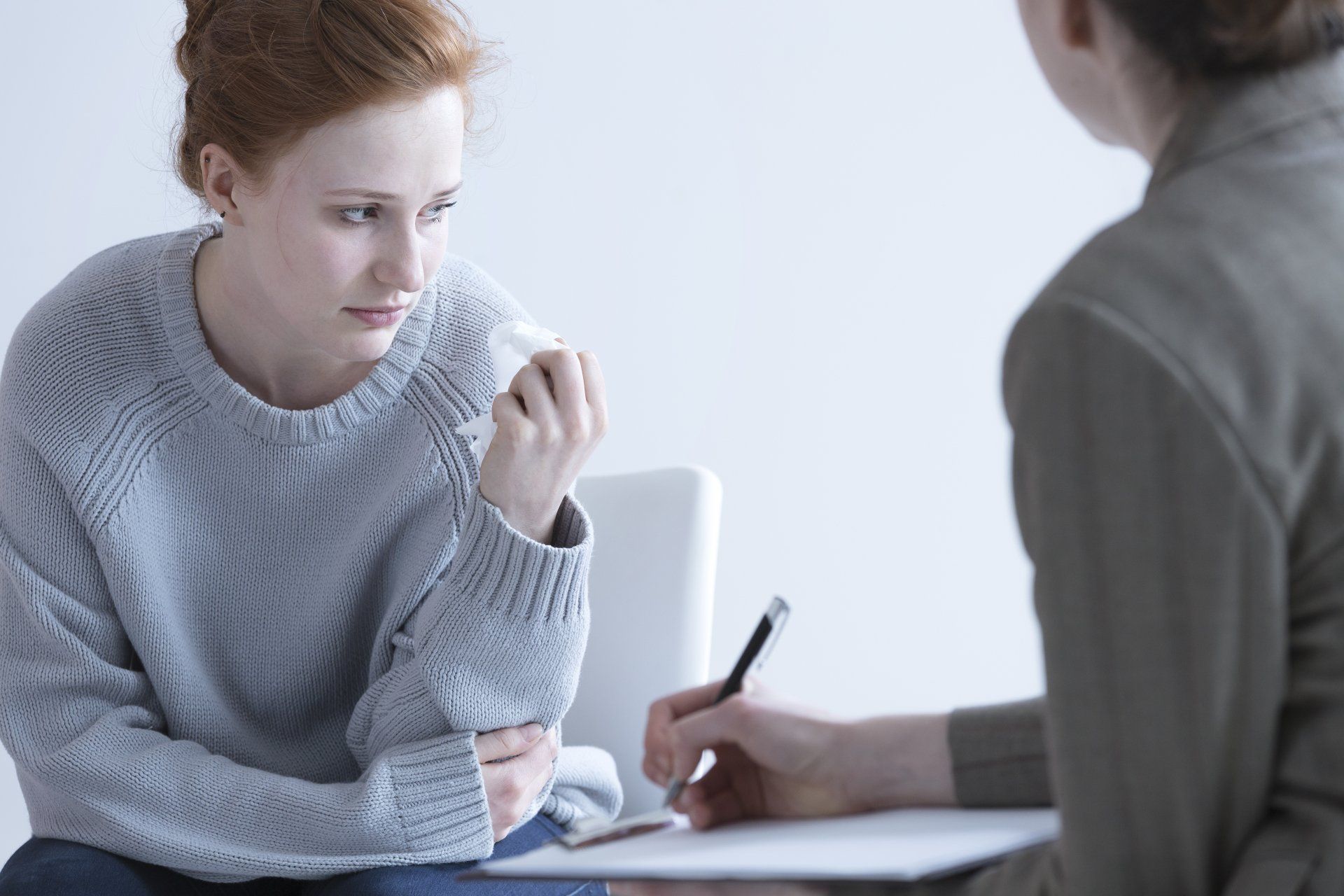 Psychologist talking with an upset woman in the office