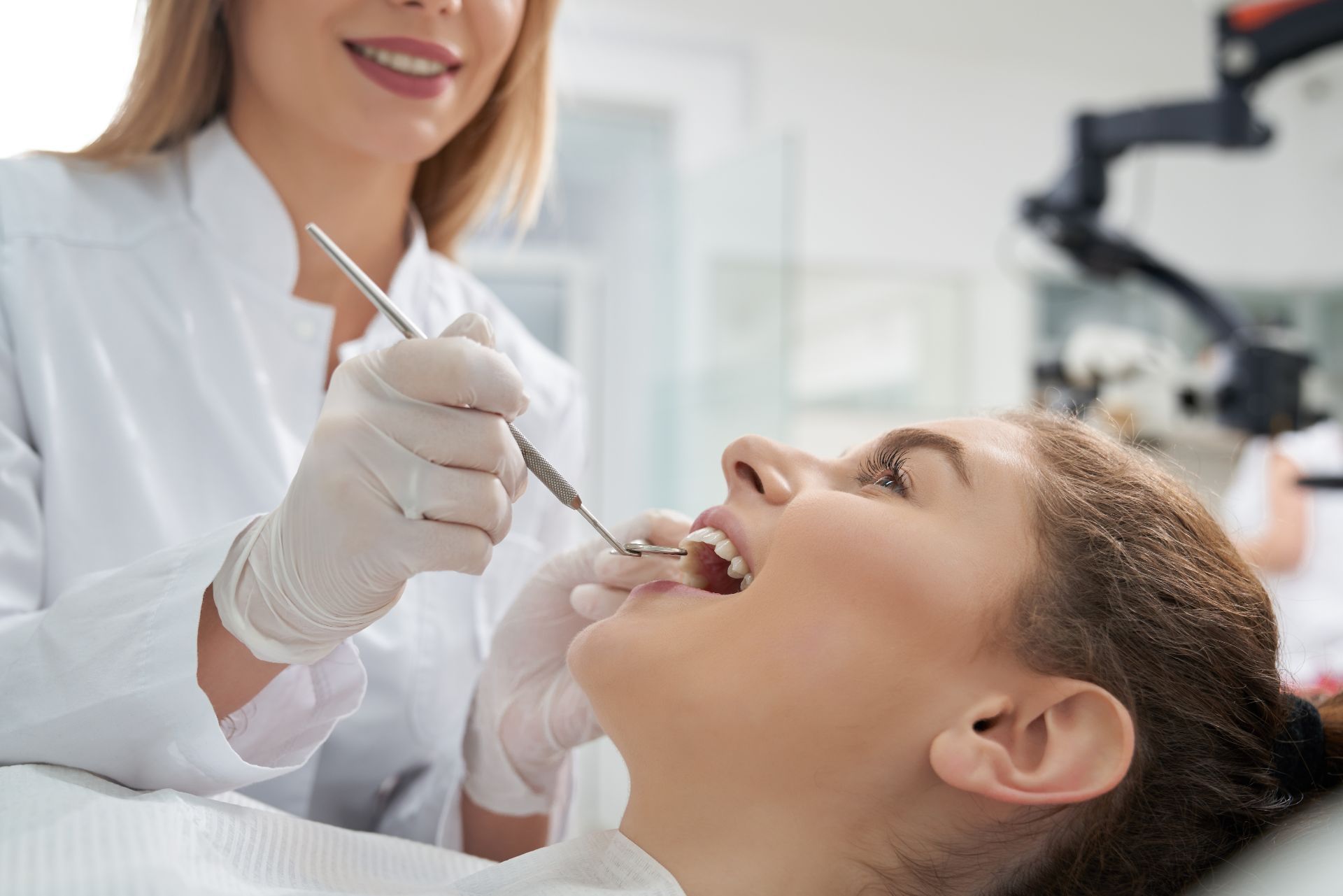 Woman having teeth examined