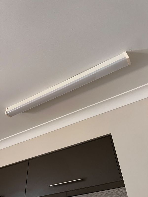 A Light Fixture is Hanging From the Ceiling in a Kitchen — AES Electrical Contracting In Winnellie, NT