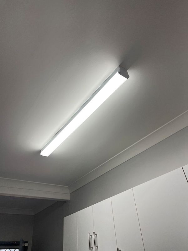A Light Fixture is Hanging From the Ceiling in a Kitchen — AES Electrical Contracting In Winnellie, NT