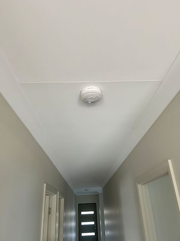 A Hallway With a Smoke Detector on the Ceiling — AES Electrical Contracting In Winnellie, NT