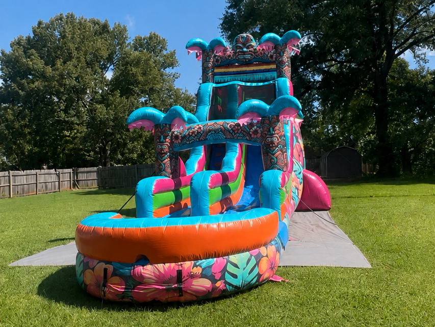 Colorful inflatable water slide on a grassy lawn under a sunny sky
