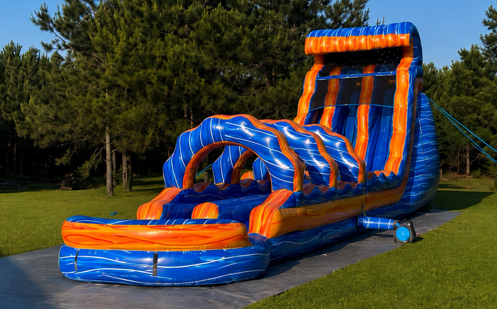 Blue and orange inflatable water slide on a grassy lawn beside trees