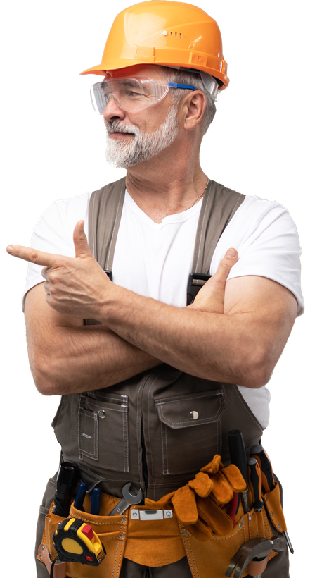 A man wearing a hard hat and safety glasses is pointing to the side.