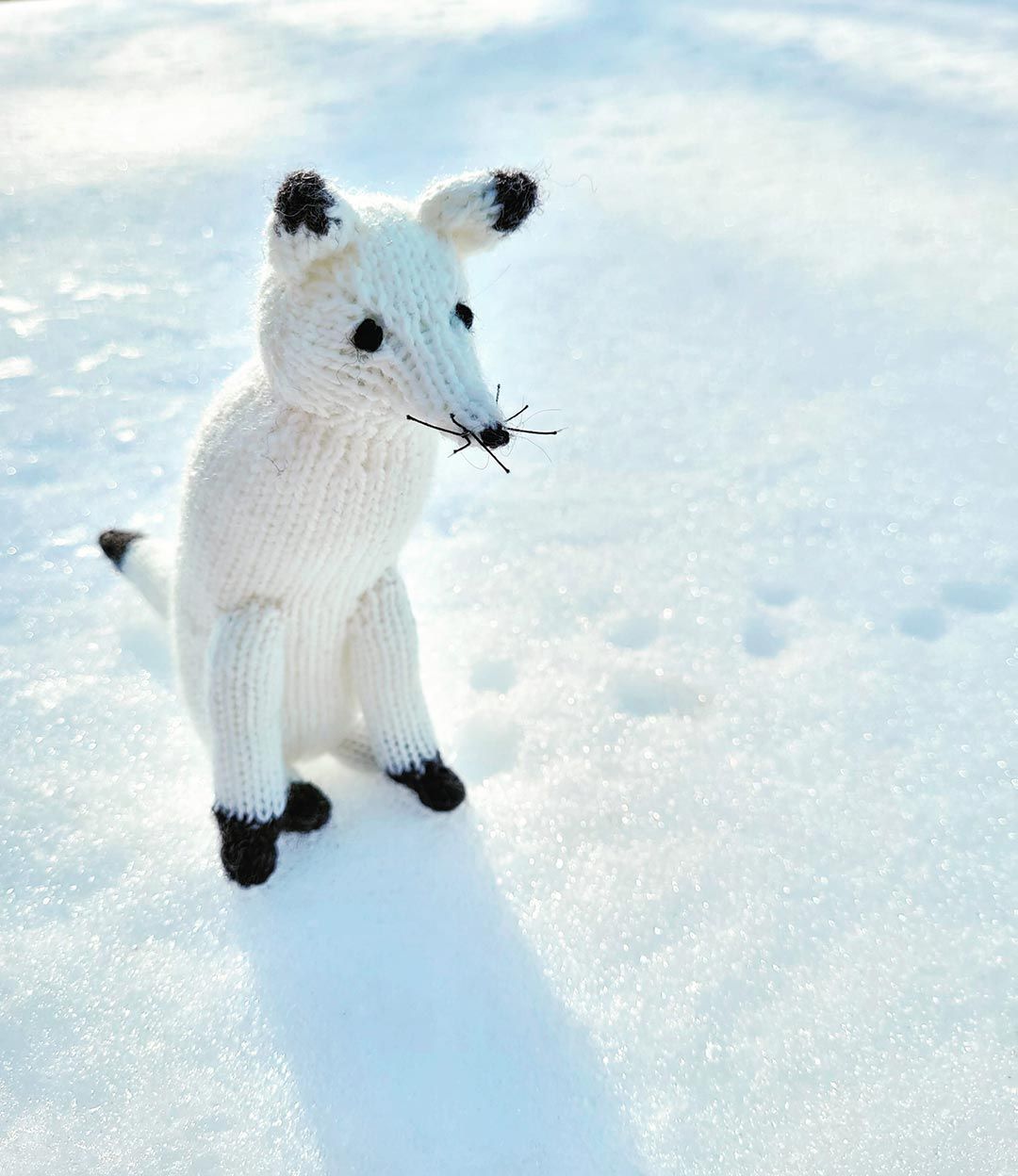 Knitted white arctic fox.