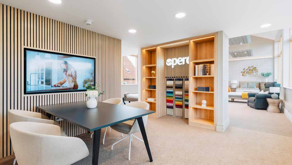 Modern office meeting room with wood accents, black table, white chairs, and display wall