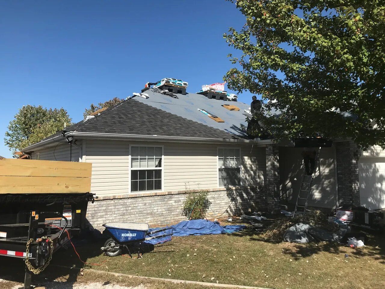 A house is being remodeled with a truck parked in front of it.