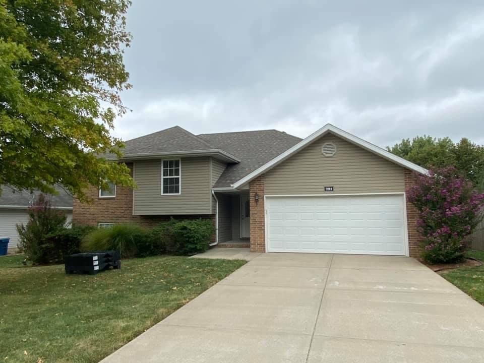 A house with a white garage door and a driveway.