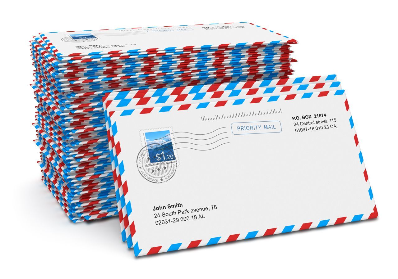 A stack of red white and blue envelopes with a stamp on them