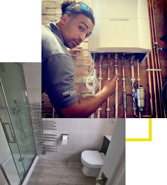 A man is working on pipes in a bathroom