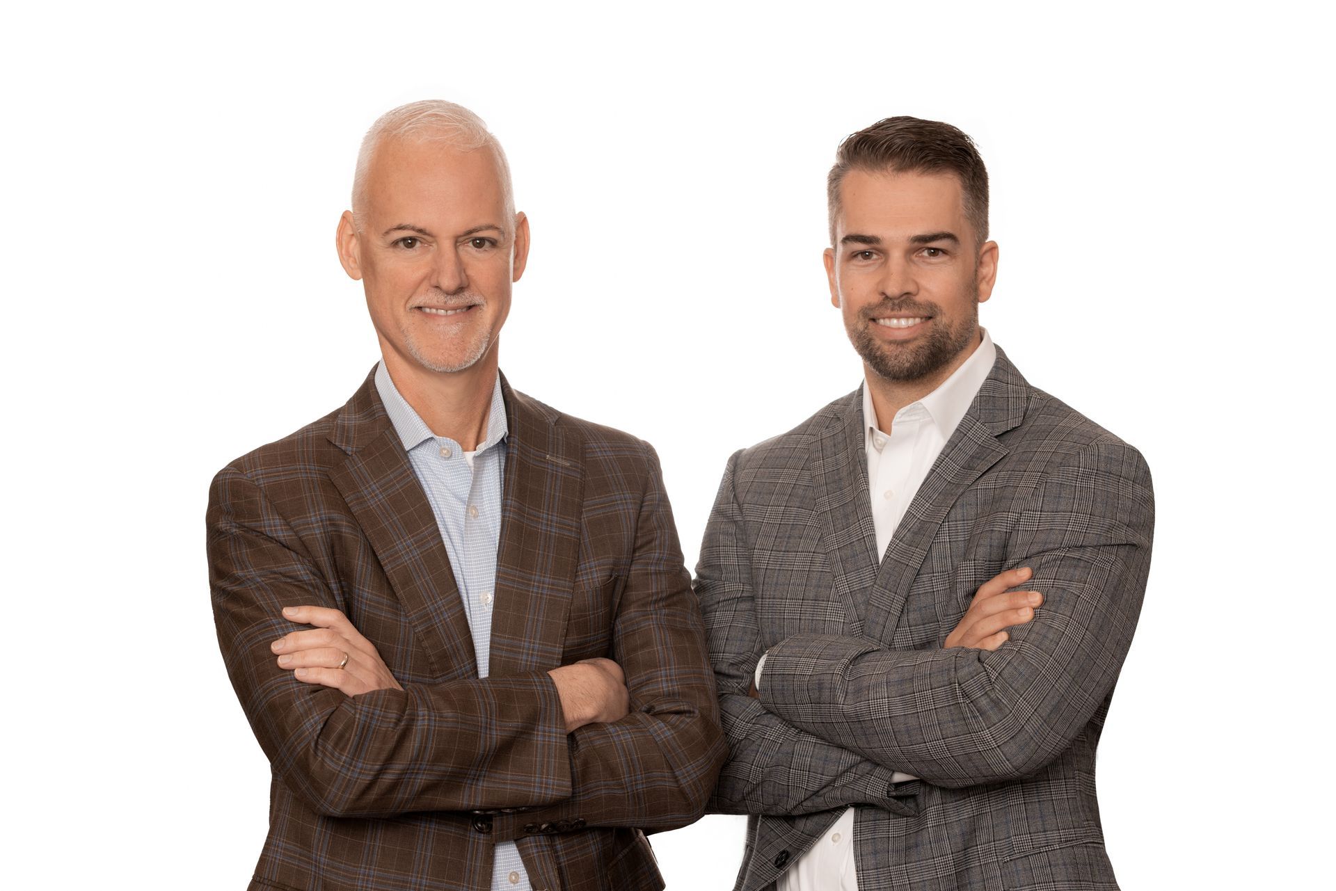 Two Florida Design Consultant team members in suits are standing next to each other with their arms crossed.