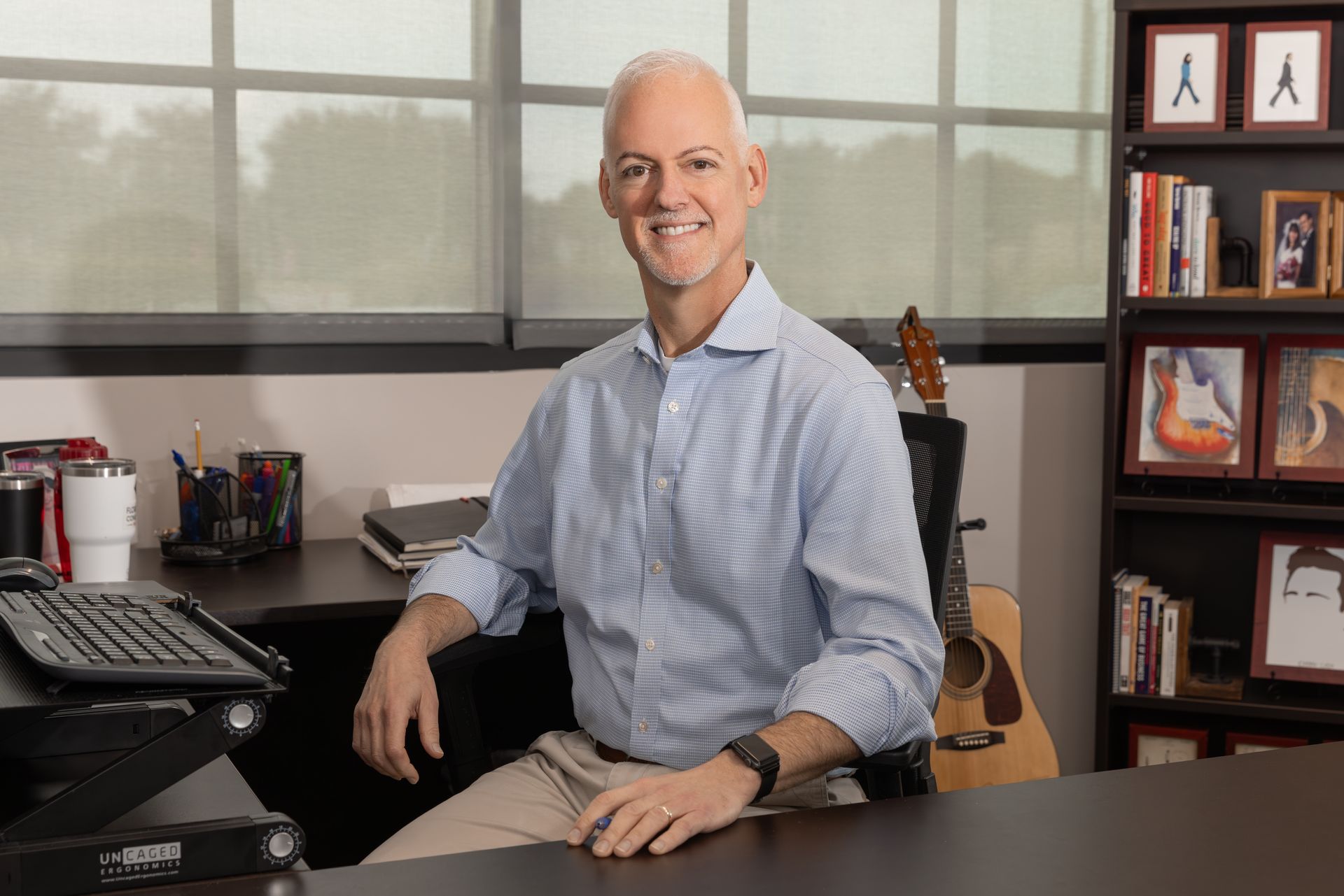 A Florida Design Consultants employee is sitting at a desk at the office.