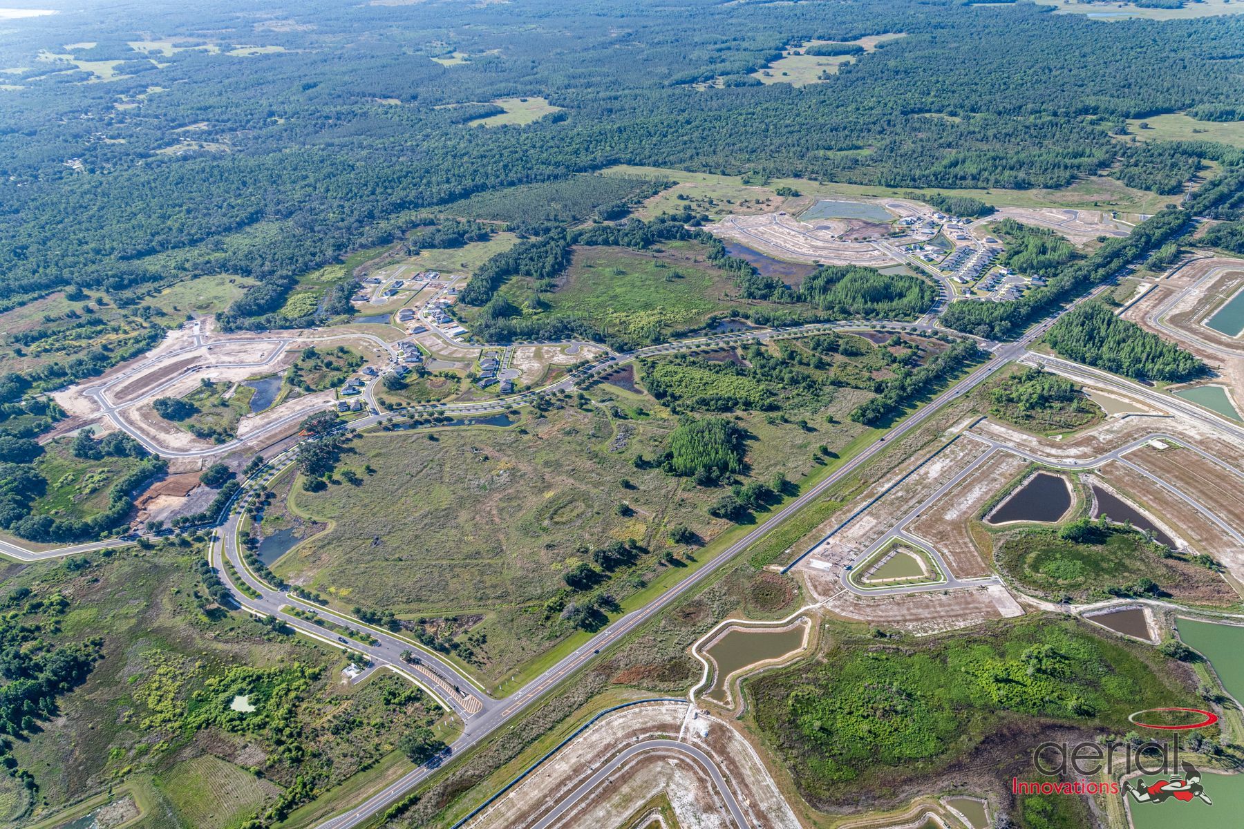 An aerial view of a construction site with a lot of trees and roads.