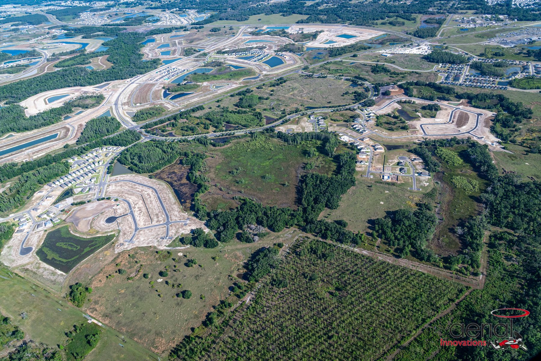 An aerial view of a large residential area with lots of trees and roads.