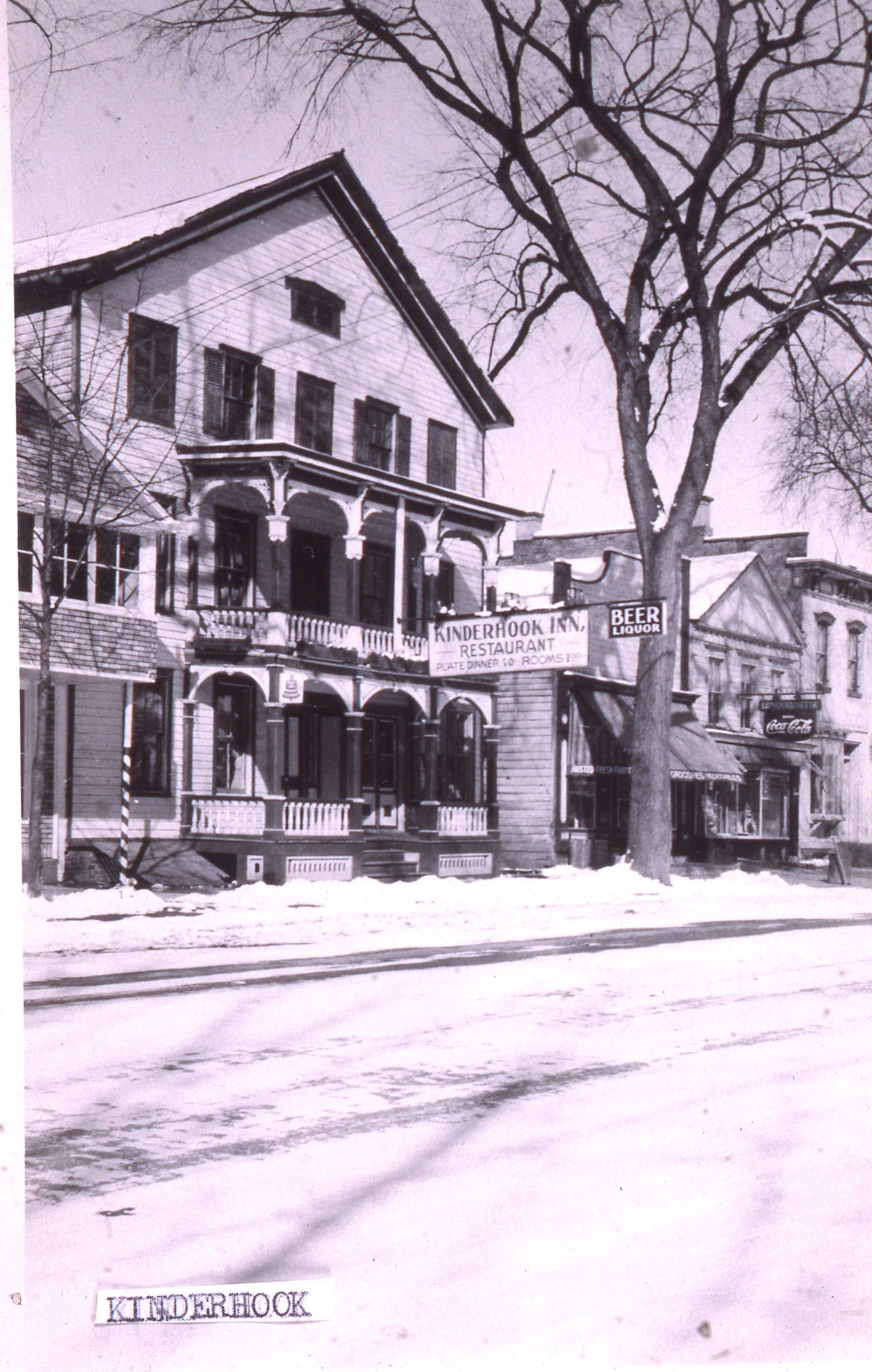 A photo from the mid 1930s or early 1940s showing a hotel with a hanging sign that reads Kinderhook Inn.