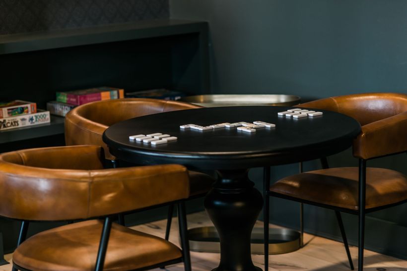 dominoes being played on a card table
