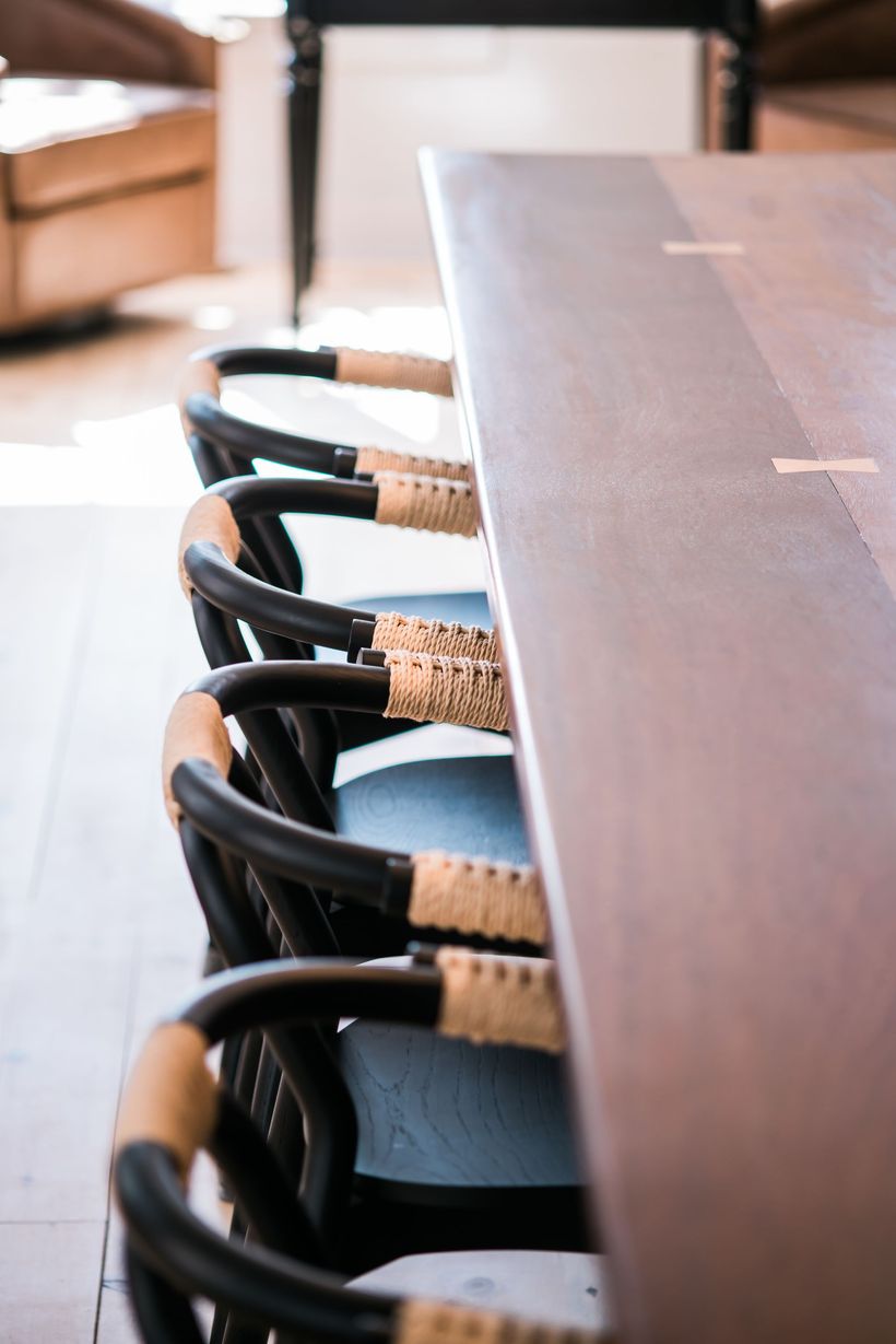 black chairs seated at a wood table