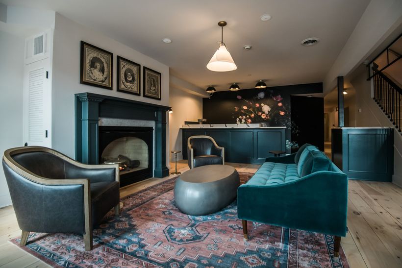 a lounge room with blue couch and fireplace