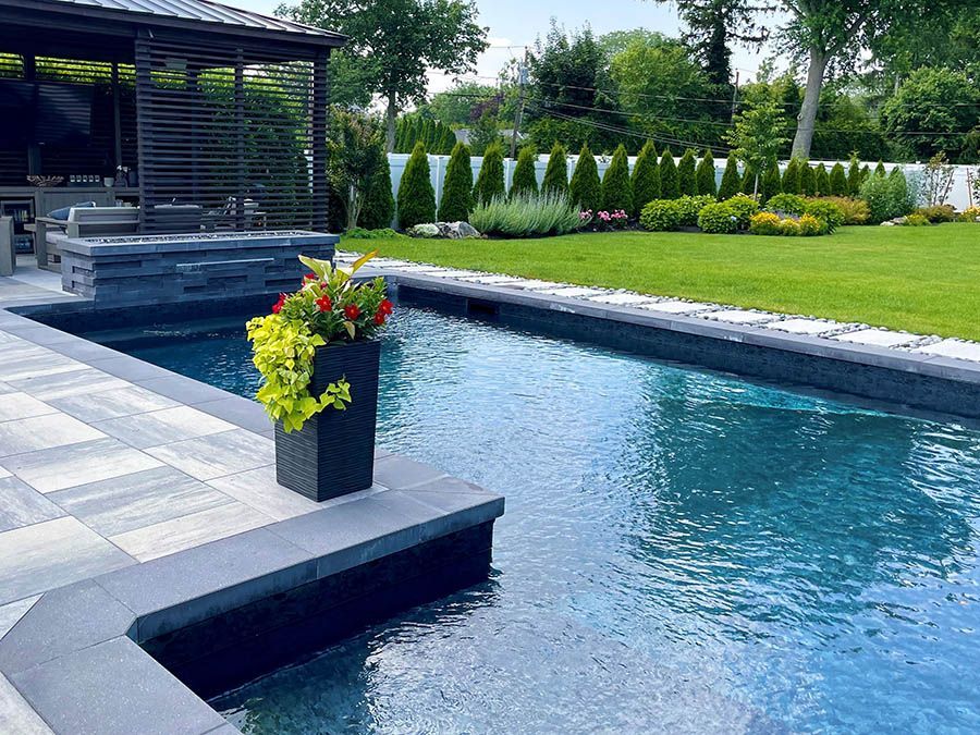 A large swimming pool with a planter of flowers in the middle of it.