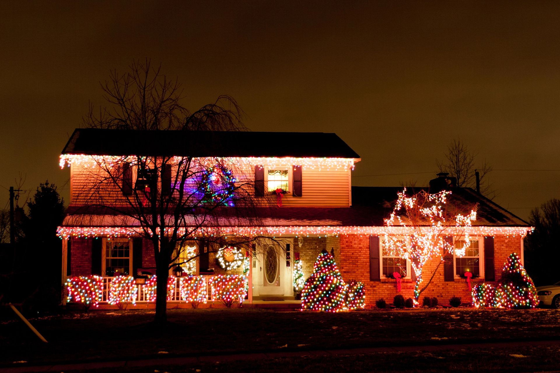A house is decorated with christmas lights at night