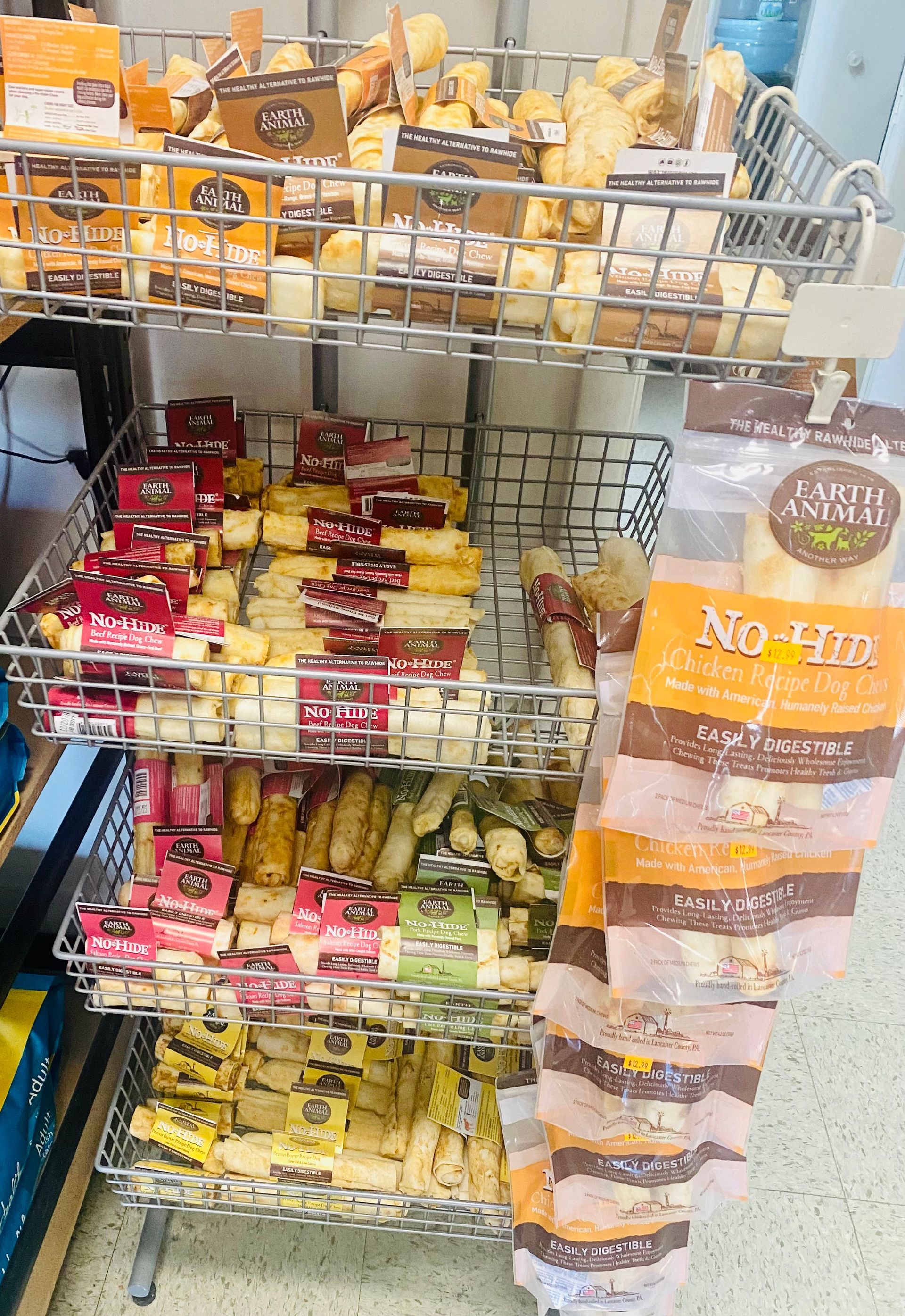 Snack rack in a store aisle with packaged bars and crackers in red, yellow, and orange wrappers