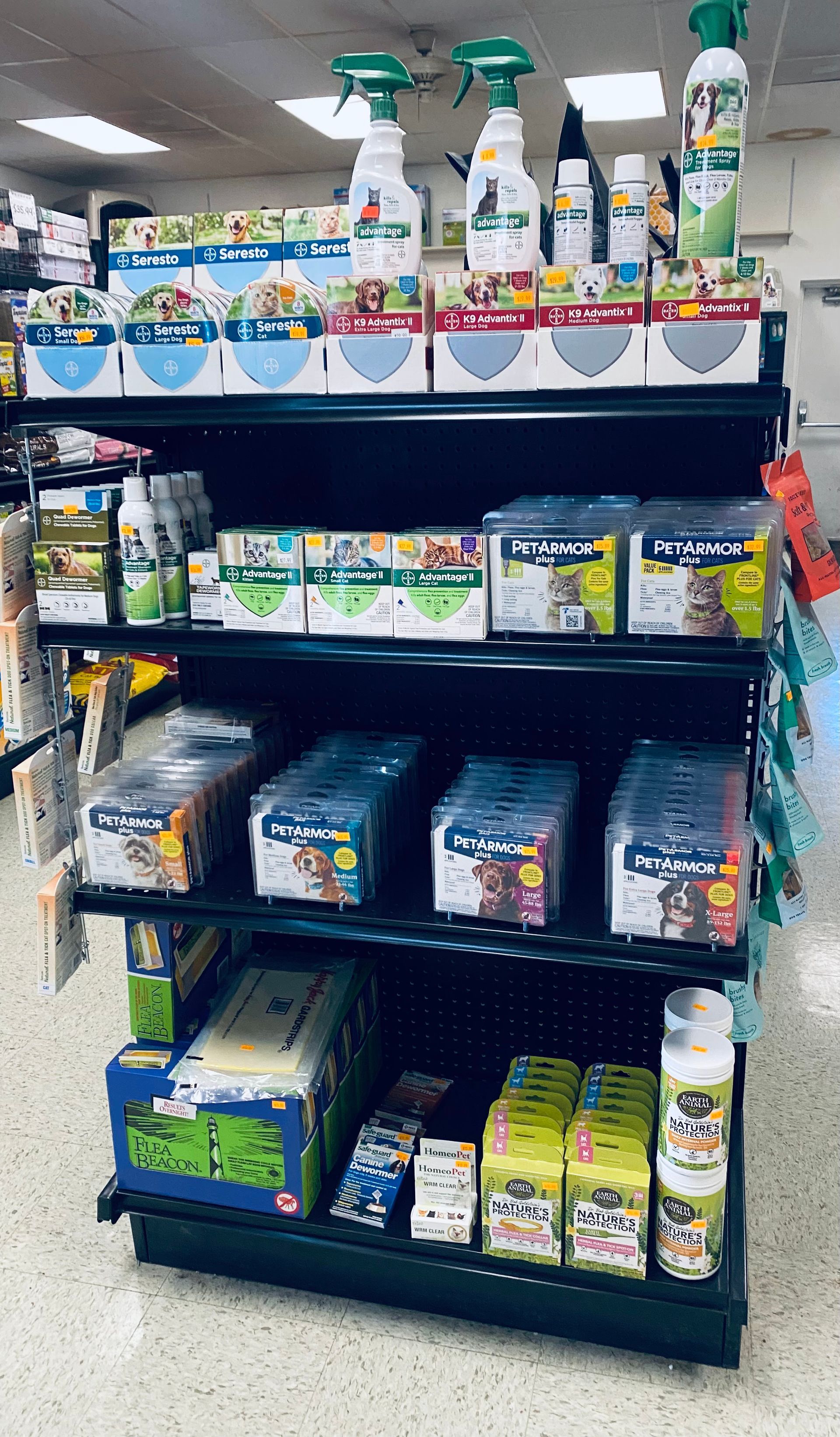 Store shelf stocked with assorted cleaning sprays, wipes, and detergent products.