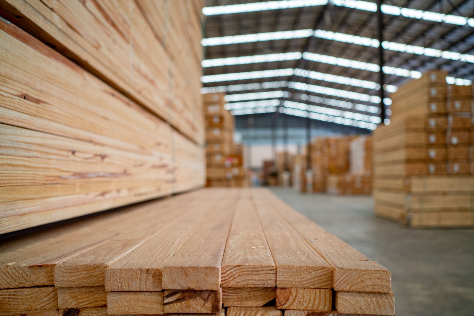 Stacked timber planks in a warehouse for flooring supply. Stacked timber planks in a warehouse for flooring supply.
