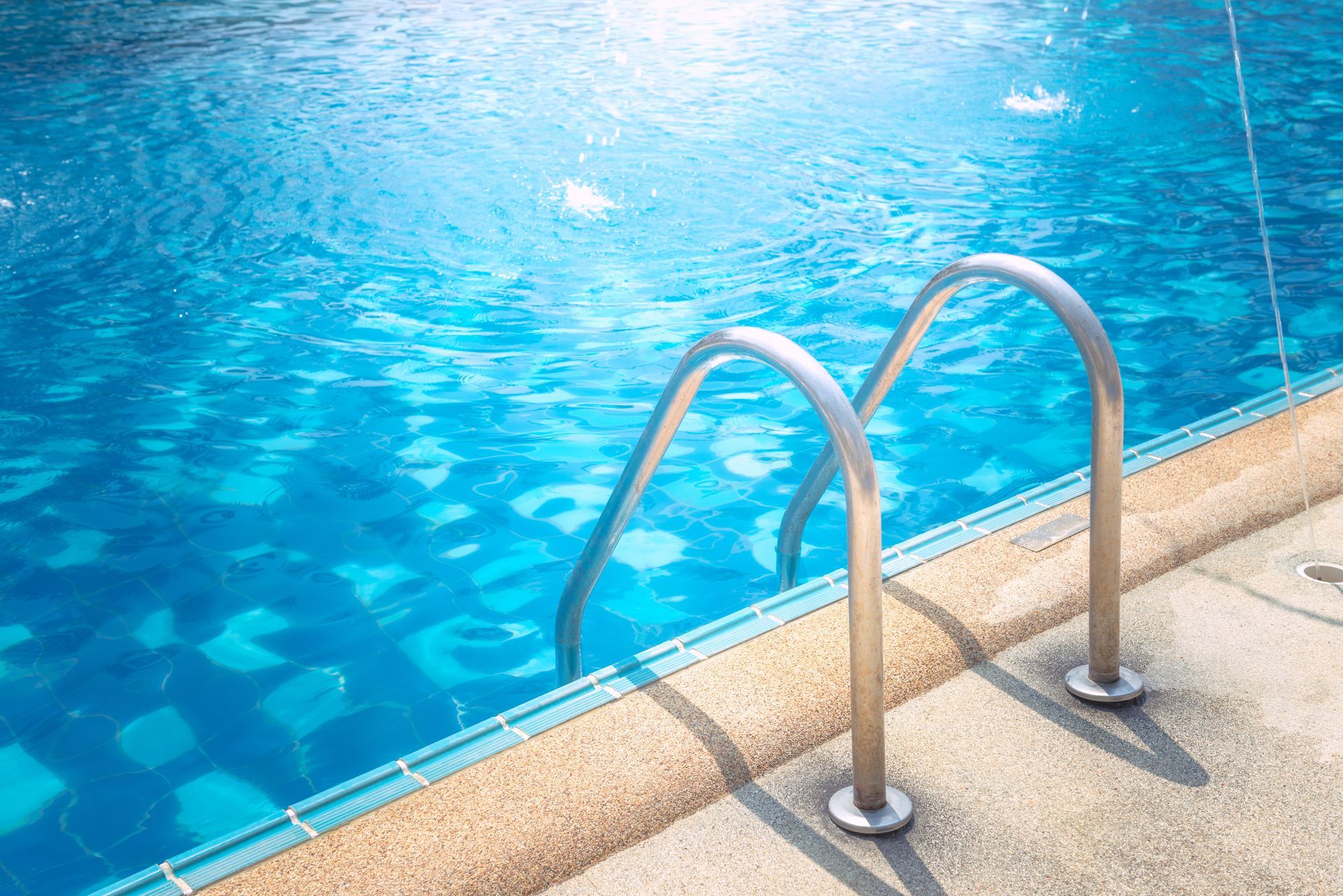 A swimming pool with stairs leading into the water.