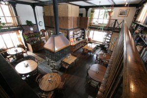 An aerial view of a restaurant with tables and chairs and a fireplace.