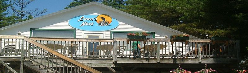 A house with a balcony and a sign that says ' lazy days ' on it