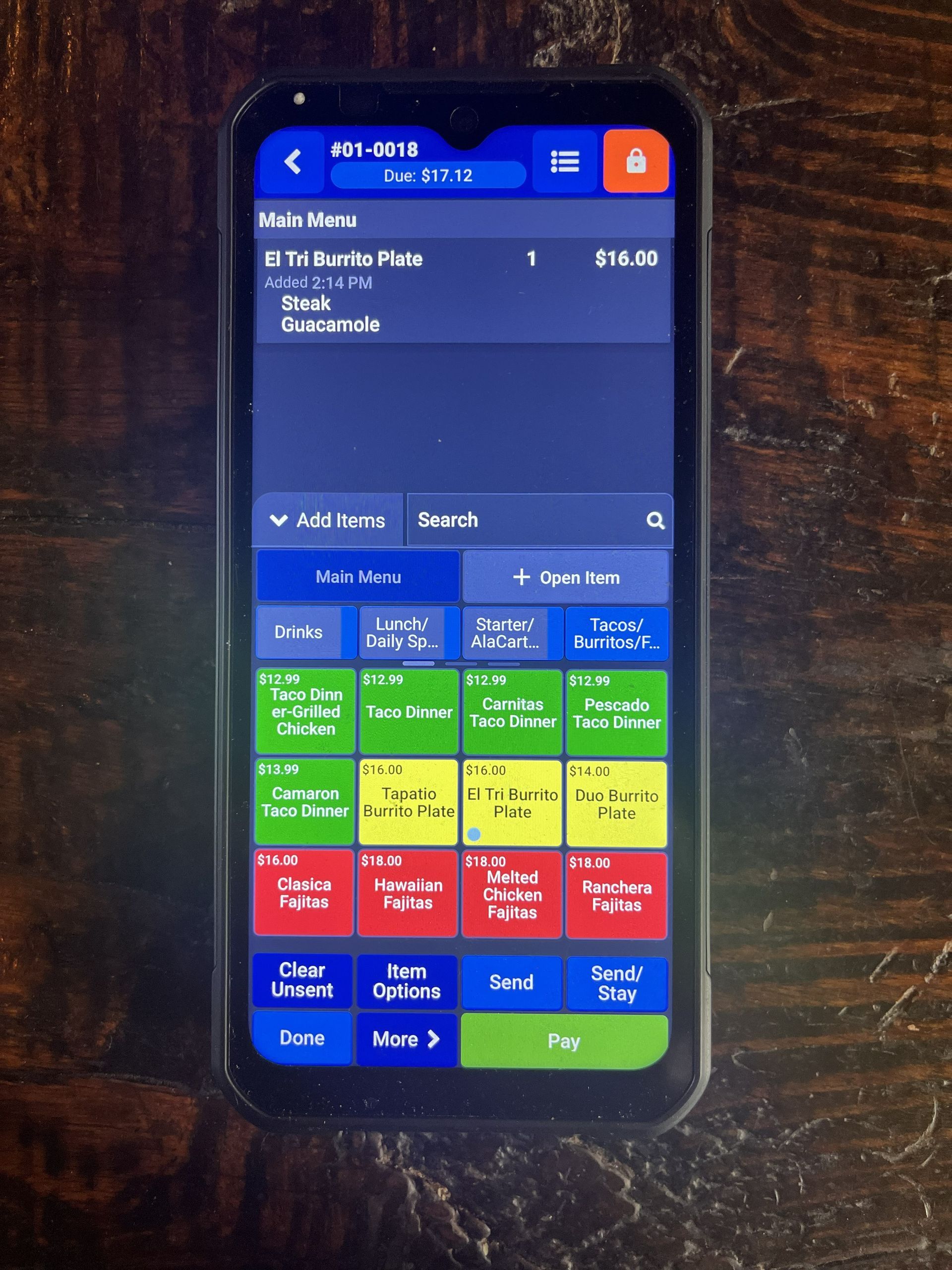 Handheld Table Turn POS device used for tableside ordering and credit card payments at a restaurant and bar in Minburn, Iowa.