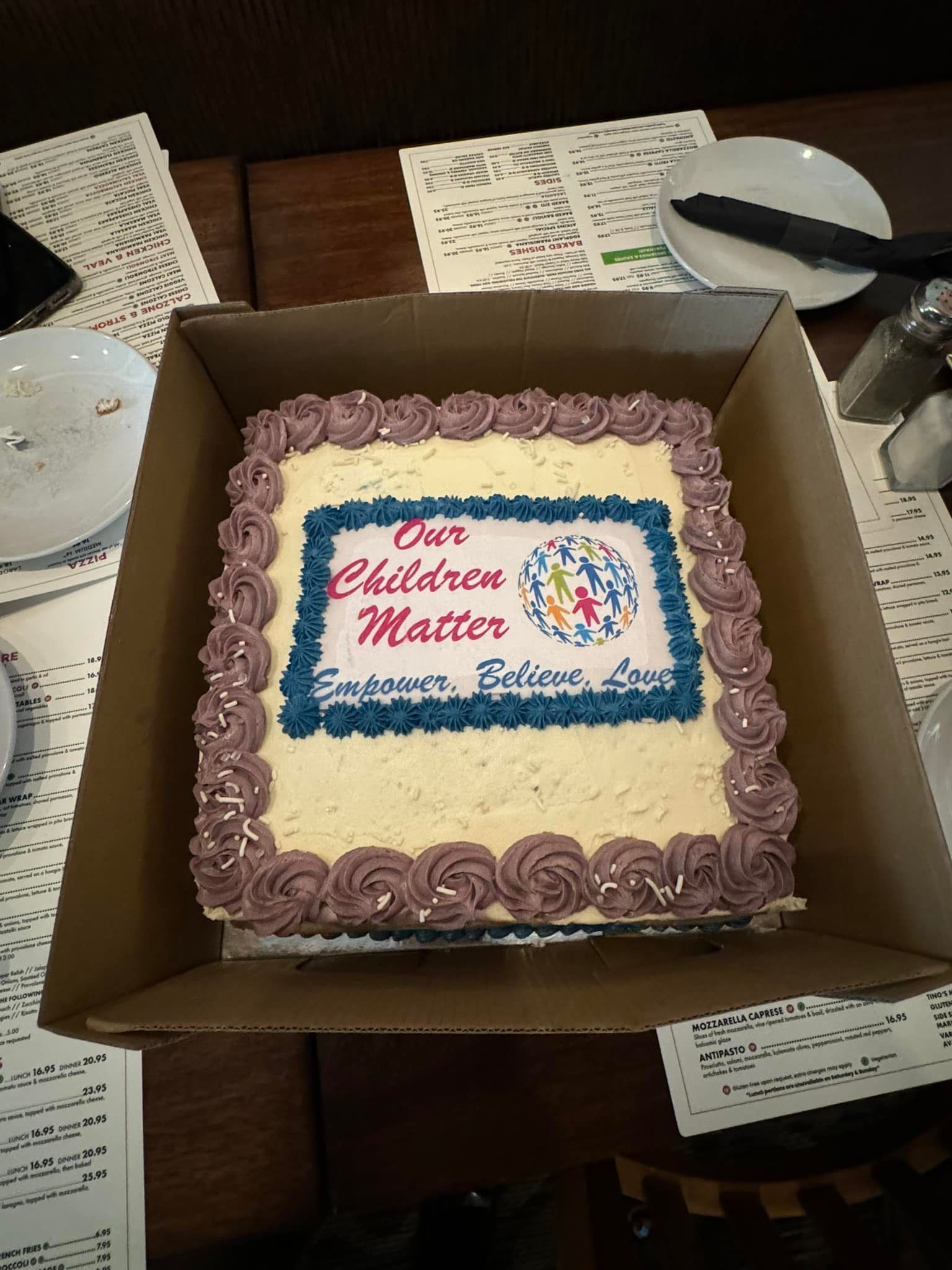 Cake in a box, decorated with frosting and text that reads 