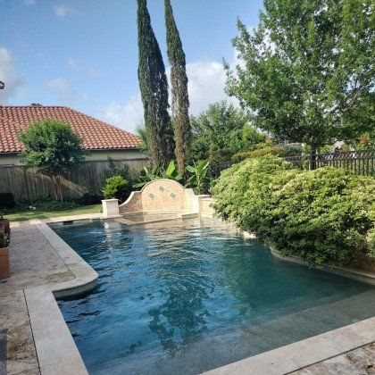 Professional media blast cleaning pool surface for restoration.