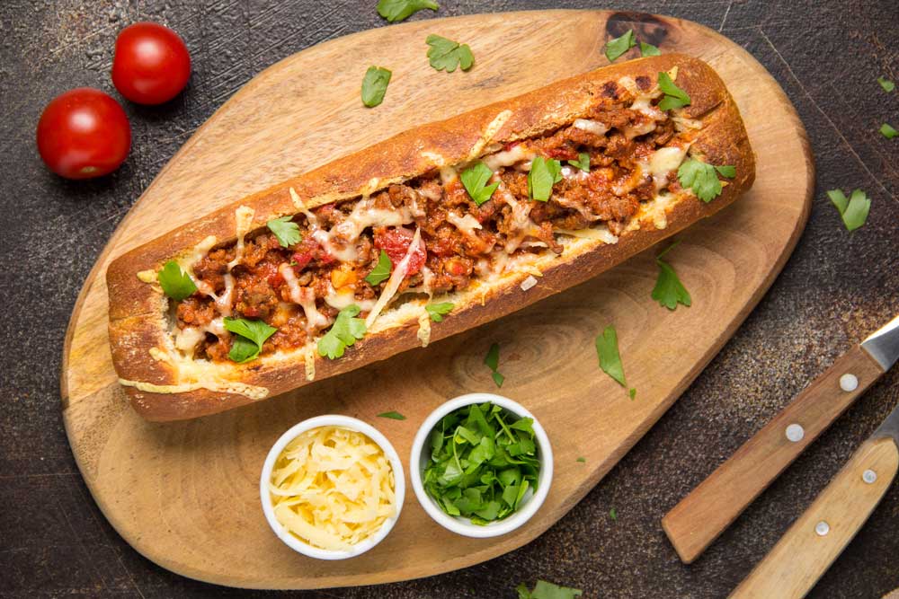 Baguette stuffed with bolognese ragout of ground beef, tomatoes and cheese