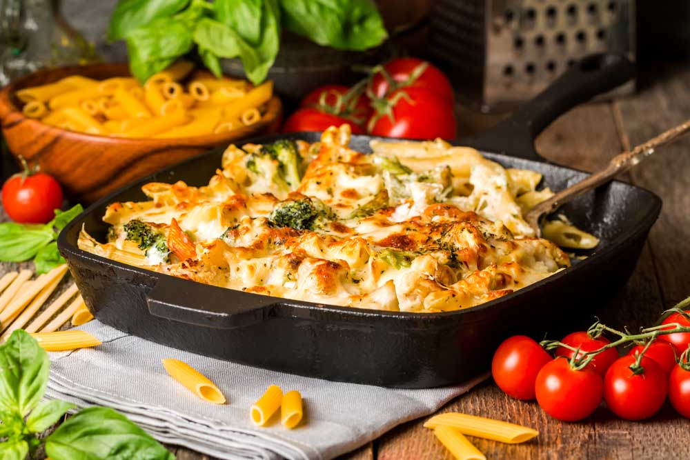 Baked pasta with broccoli, cauliflower, cheese and bechamel sauce