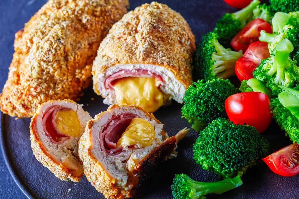 Chicken Cordon Bleu baked in oven with ham and cheese stuffing