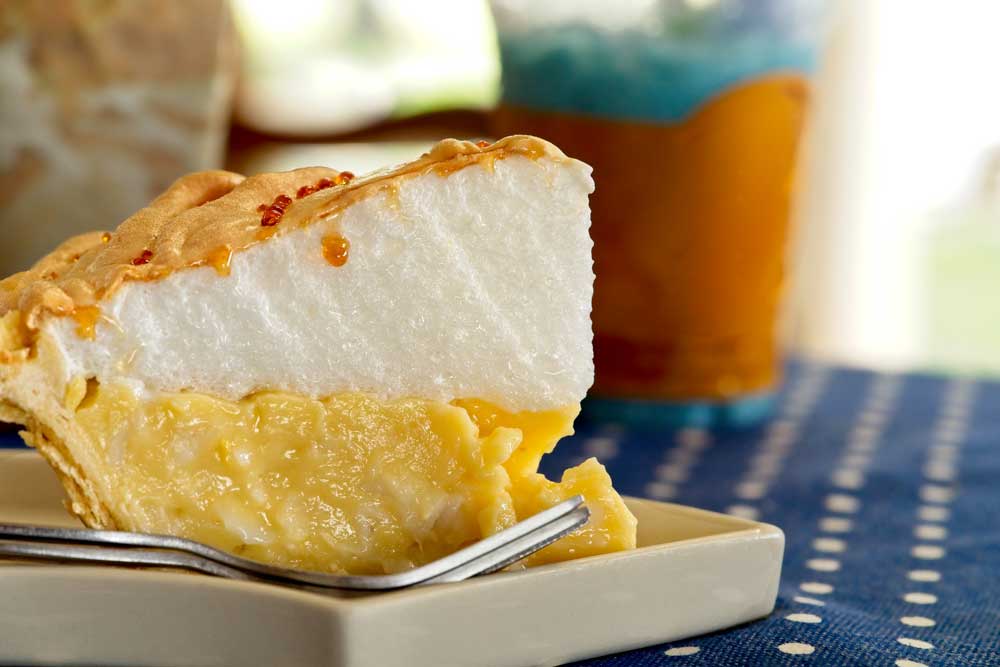 Close up Coconut Cream Meringue Pie on vintage table