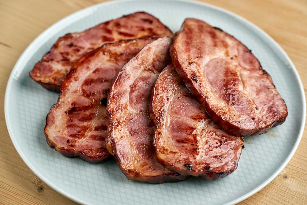 Closeup of a plate with juicy pork neck fresh off the grill