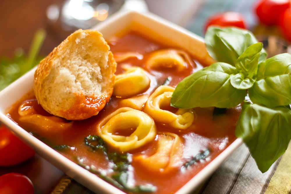 Hearty tortellini tomato soup with spinach and basil