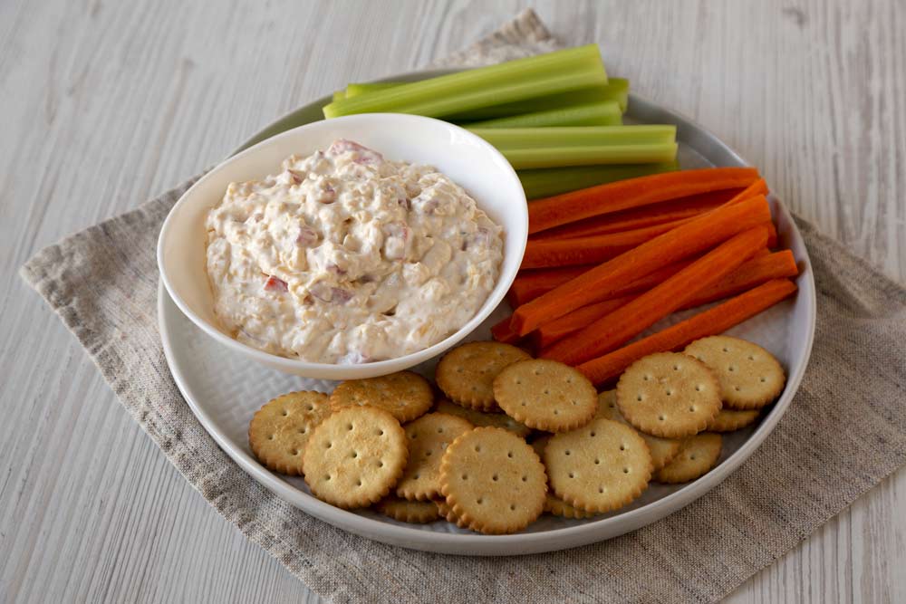 Homemade Pimento Cheese Dip with carrots, celery and crackers