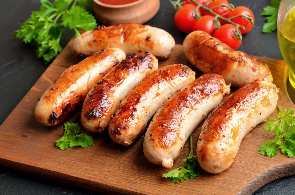 Homemade fried sausages on cutting board
