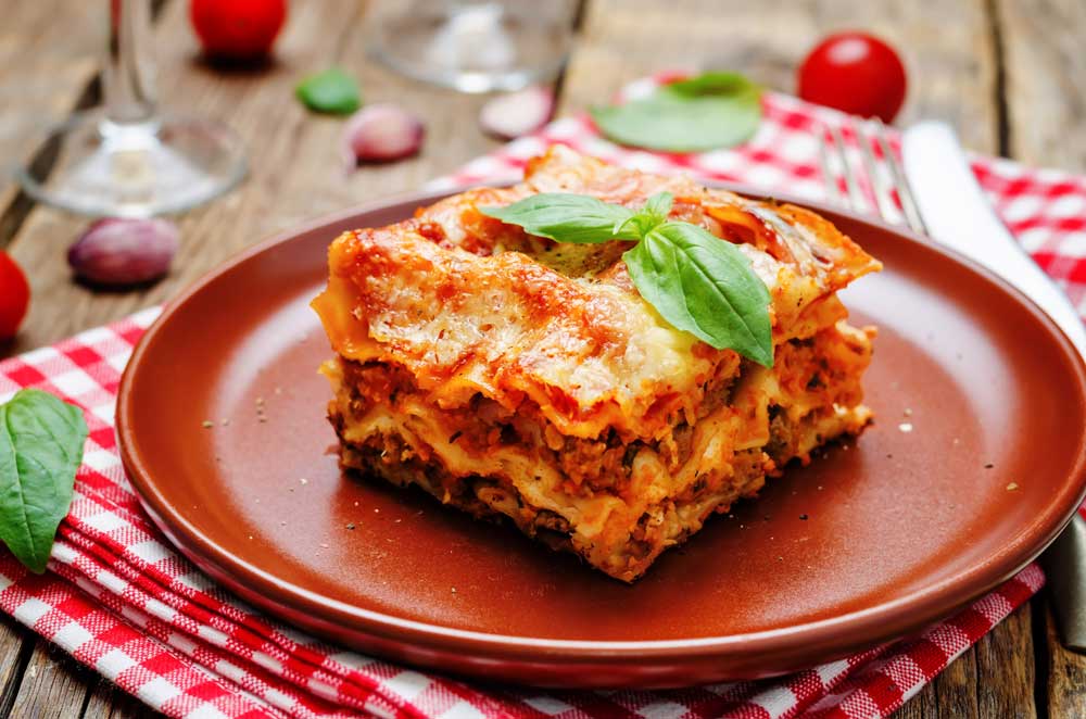 Meat lasagna on a red plate