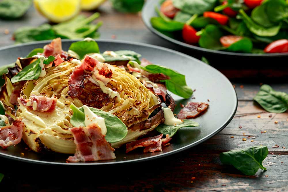Oven roasted cabbage steaks with bacon, spinach and mayonnaise