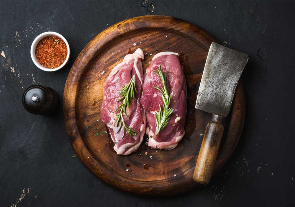 Raw duck breast with rosemary, spices
