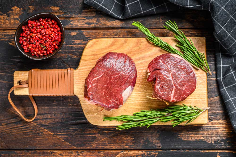 Raw fresh marbled meat Steak fillet mignon on a cutting board