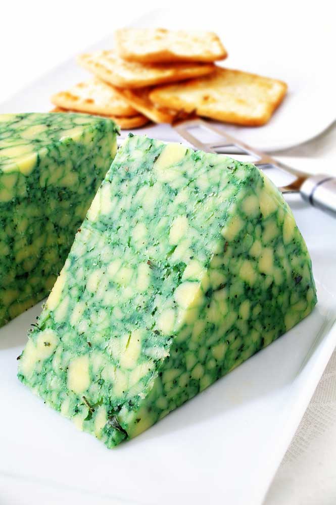 Sage derby cheese on white platter