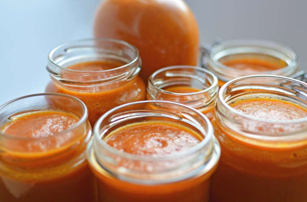 Selective-focus-image-of-jars-filled-with-chili-sauce