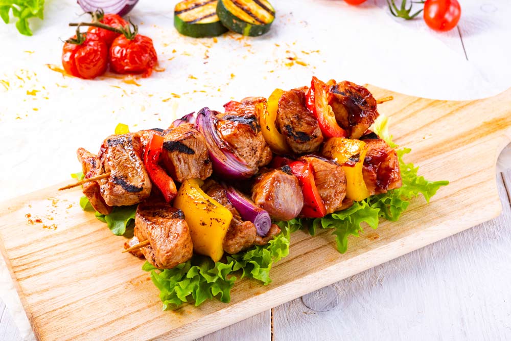 Tasty and colorful meat skewers with peppers and onions